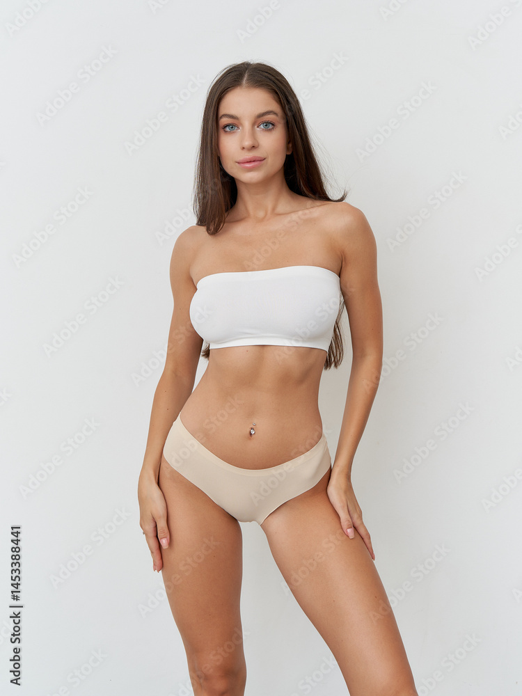 Fashion forward female model showcases modern style in studio setting Fashion forward female model showcases modern style in studio setting