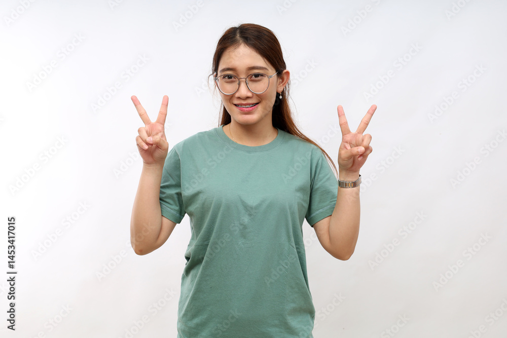 Positive charming asian woman showing victory peace signs looking camera happily smile enjoy celebration, white background Positive charming asian woman showing victory peace signs looking camera happily smile enjoy celebration, white background