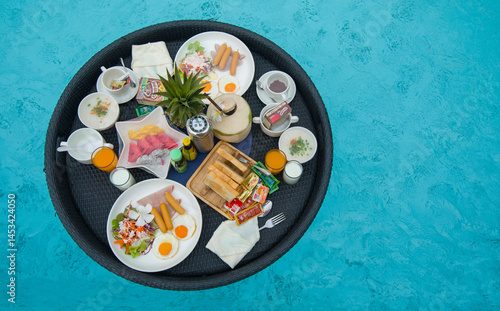 Breakfast on a plate in swimming pool