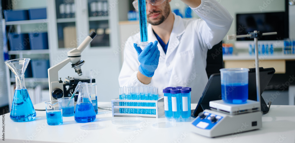 Fototapeta premium male scientist working with micro pipettes analyzing biochemical samples, advanced science chemical laboratory for medicine.