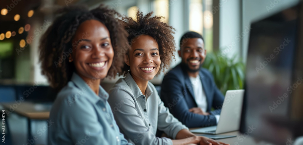 Obraz premium A diverse group of confident professionals smiling in a bright modern office, exuding positivity and tech-savvy collaboration.