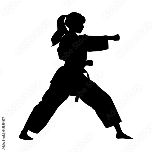 Silhouette of female karate martial artist executing a punch