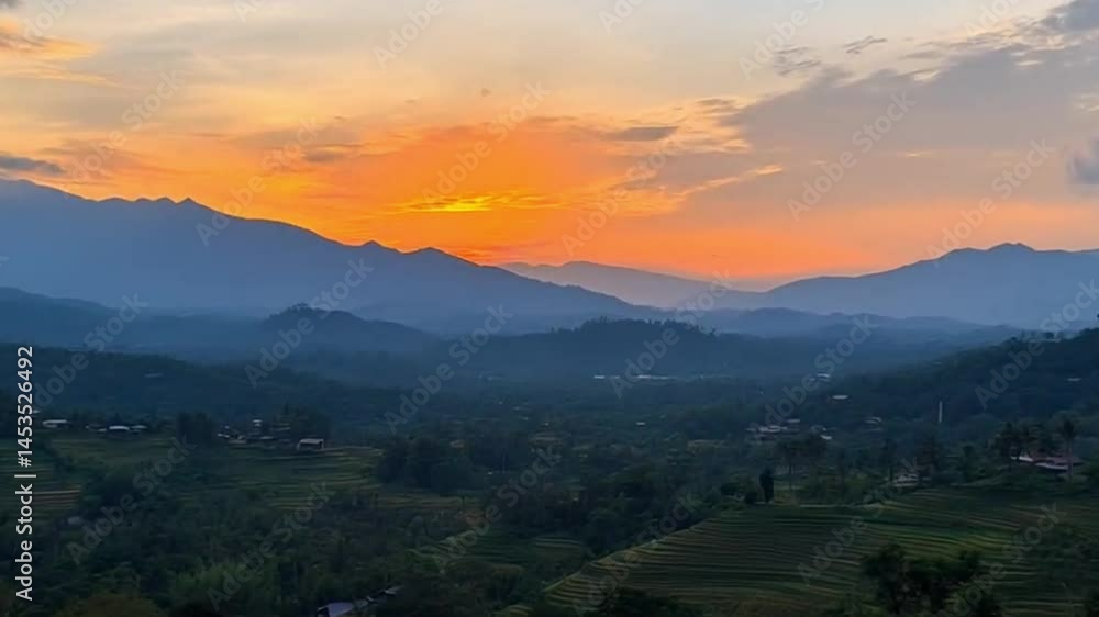 Sunset over a valley with terraced rice paddies, misty mountains, and villages nestled in the valleys. A breathtaking view of nature Sunset over a valley with terraced rice paddies, misty mountains, and villages nestled in the valleys. A breathtaking view of nature