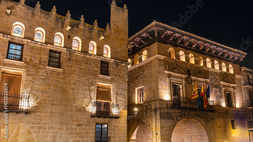 Monumental buildings in medieval style seen at night in the town of Valderrobles, Teruel.