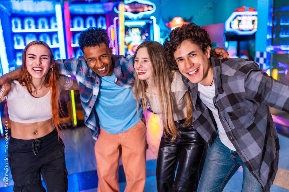 Happy multiethnic friends enjoying time together at the arcade