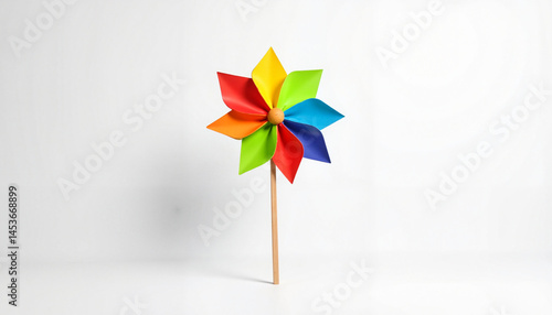 Colorful pinwheel spinning in bright white background  