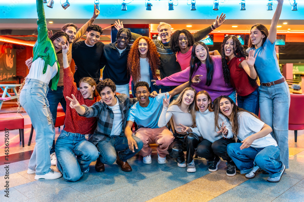 Happy multiethnic friends enjoying bowling alley games