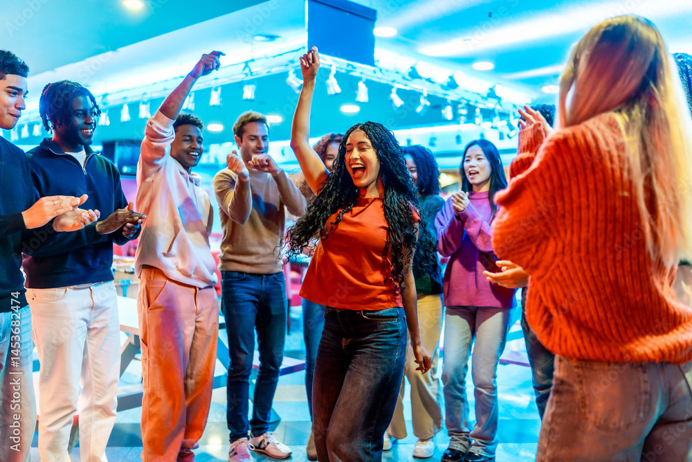 Young multiethnic friends enjoying bowling alley weekend party