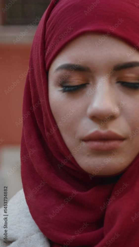 A captivating portrait of a woman in a striking red hijab, showcasing poise and serenity A captivating portrait of a woman in a striking red hijab, showcasing poise and serenity