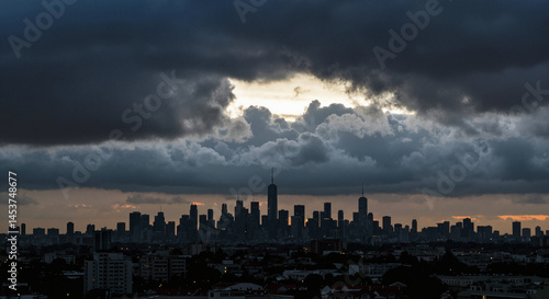 City skyline amid dark clouds during blackout in urban areas  