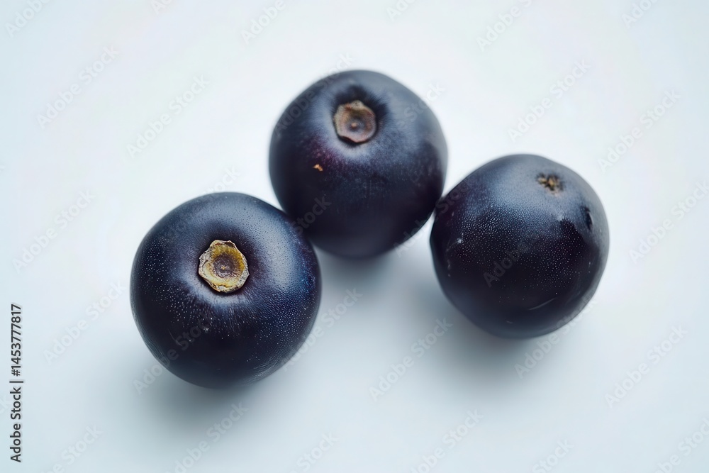 Fresh blackcurrants arranged artistically on a light background, showcasing their rich color Fresh blackcurrants arranged artistically on a light background, showcasing their rich color