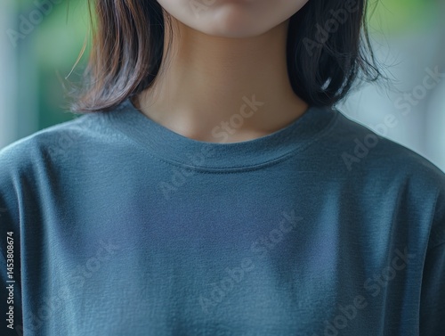 Person in blue pullover for relaxed wear, possibly after exercise or outdoors due to moisture on shirt.