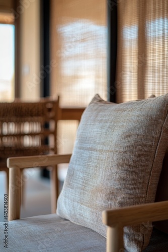 Obraz na płótnie A chair with a pillow on it. The pillow is tan and has a pattern. The chair is wooden and has a back. The room is well lit and has a cozy atmosphere w salonie