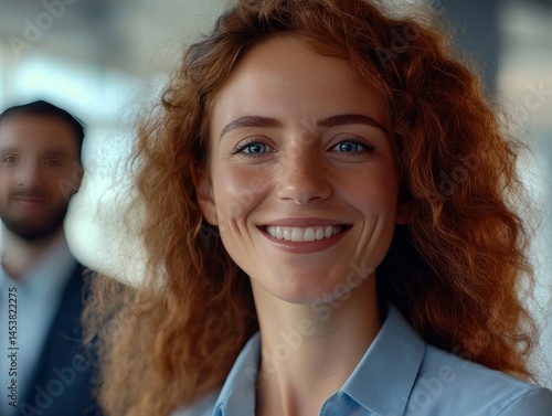 Obraz na płótnie Smiling businesswoman with reddish hair, wearing a blazer and posing for camera during a professional engagement. w salonie