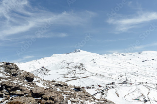 Sierra Nevada ski resort offering stunning views of snowy mountain peaks under blue sky
