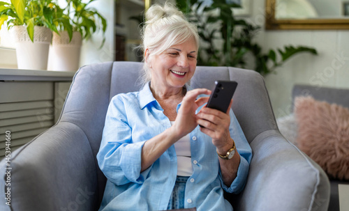 Senior woman using mobile phone at home
