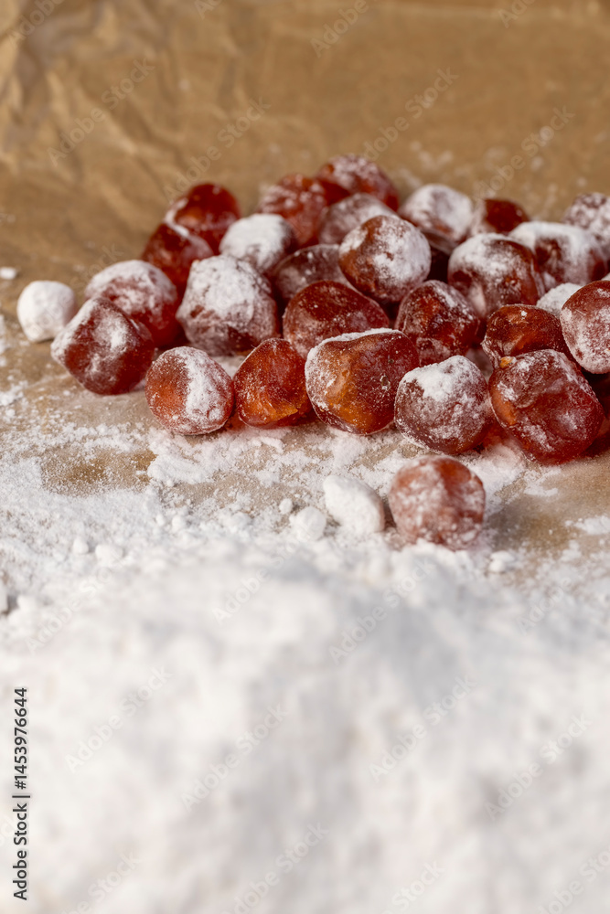 candied fruits of kumquat boiled in sugar syrup in powdered sugar, sweet dehydrated candied fruits