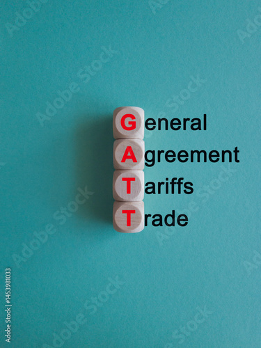Obraz na płótnie GATT ( General Agreement on Tariffs and Trade) - acronym on wooden cubes on beautiful blue background. Business concept. w salonie