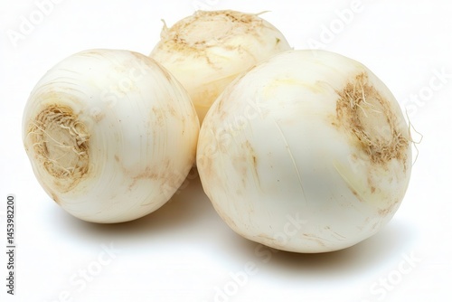 Three fresh, round turnips arranged closely, highlighting their smooth texture and earthy roots
