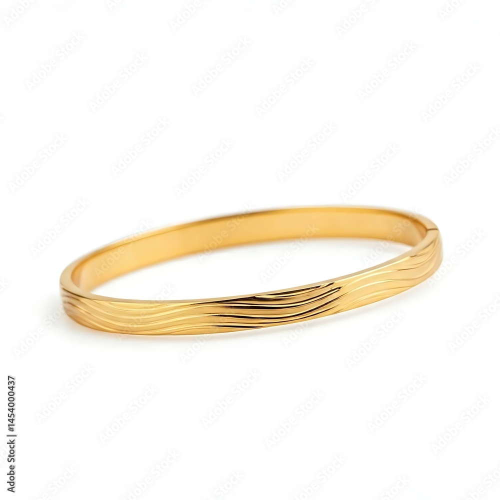 Fototapeta premium Minimalist gold bangle with polished finish and wave pattern close up white studio background.