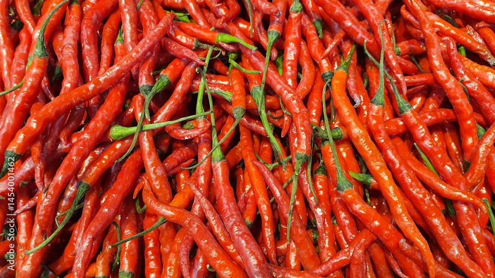 Close up pile of fresh red chilli placed together in local market as a background.
Close up pile of fresh red chilli placed together in local market as a background.