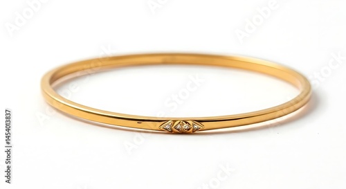 White background close-up of sleek gold bangle with triangle accents .