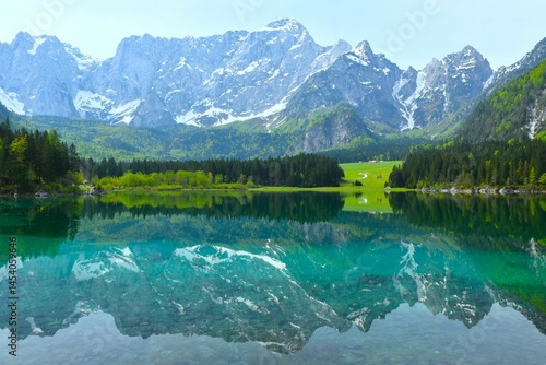 Obraz na płótnie View of lago di Fusine superiore alpine lake and Mangart mountain peak in Julian alps above in municipality of Tarvisio, Italy w salonie