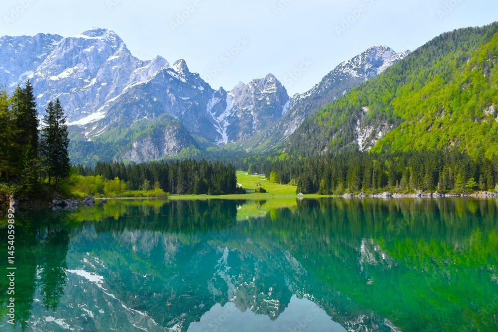View of lago di fusine superiore lake bellow mountain peaks in Julian alps in Italy