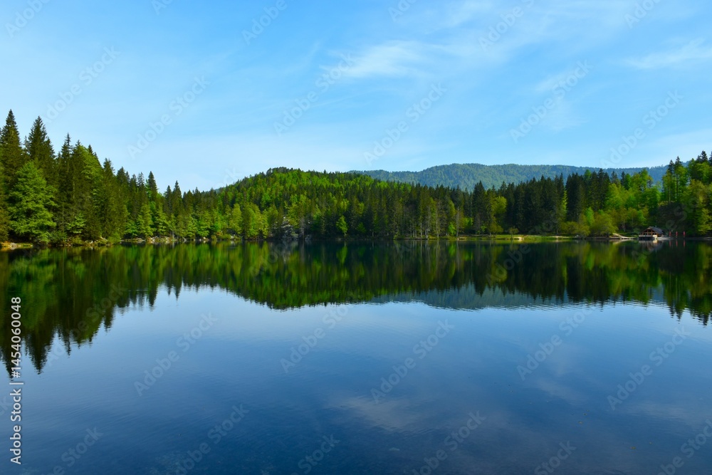 Forest covered hill above lago di Fusine inferiore in municipality of Tarvisio in Italy