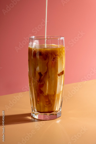 Wallpaper Mural Milk pouring into ice coffee on pink background. Torontodigital.ca