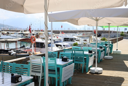 Turquoise outdoor chairs in a fish restaurant at a seaside resort. stylish cafe. High quality photo