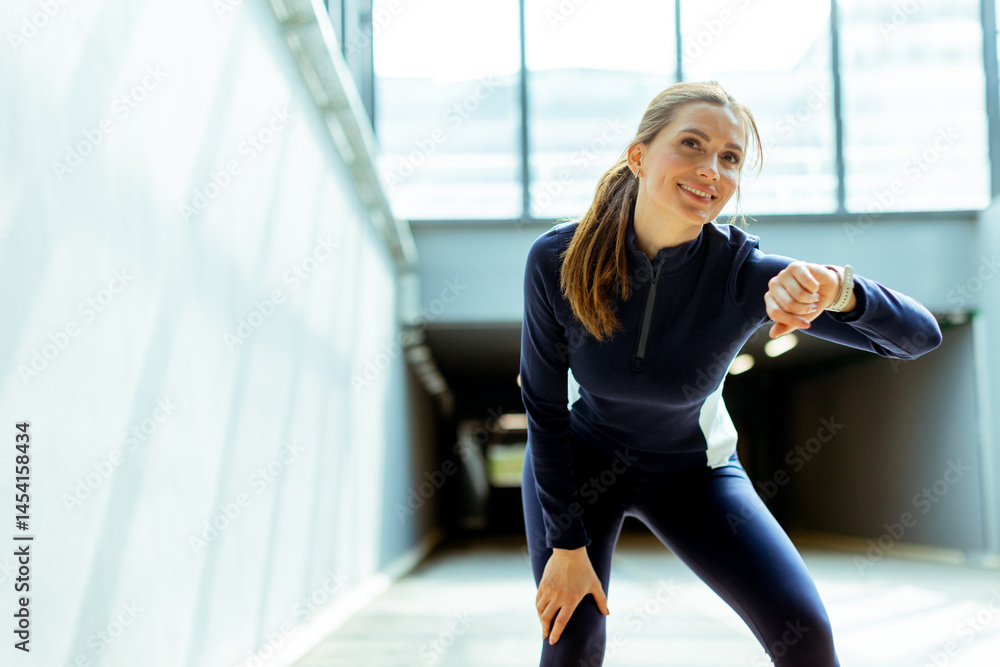 Motivated athlete taking a break while training indoors in a bright, modern gym environment
