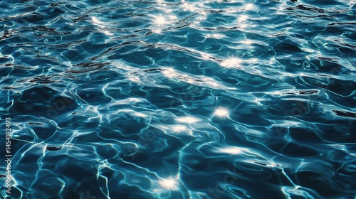 Blue tiled swimming pool with light reflections on water surface.