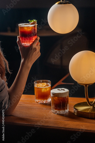 Elegant Cocktails Amber Hues and Golden Lighting in a Dark Bar