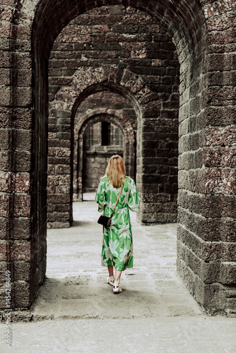 Photography Goa, India - February 20, 2025: A woman walking and taking photos outside of the