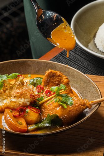 Rich Duck Confit Curry Aromatic Spiced Stew with Crispy Garnish