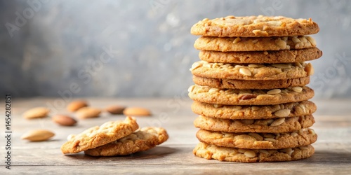 Crunchy cookies stacked high with a generous helping of chopped nuts on top, baked goods, almonds