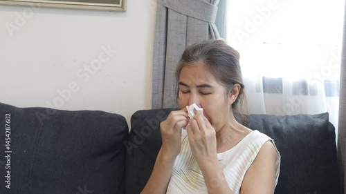 woman sneezing, covering nose, cold symptoms