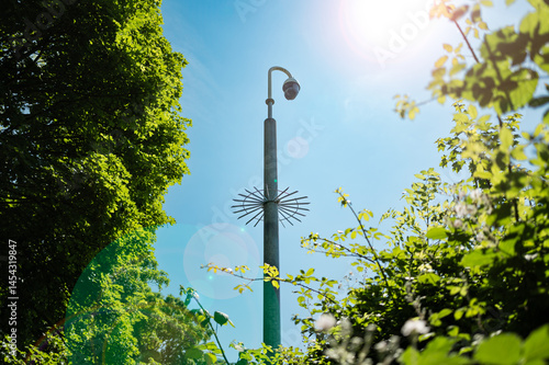 Obraz na płótnie Newly installed, vandal proof city CCTV dome camera seen in an area of high crime in a British city centre. The CCTV camera overlooks parkland and buildings known for drug dealing. w salonie