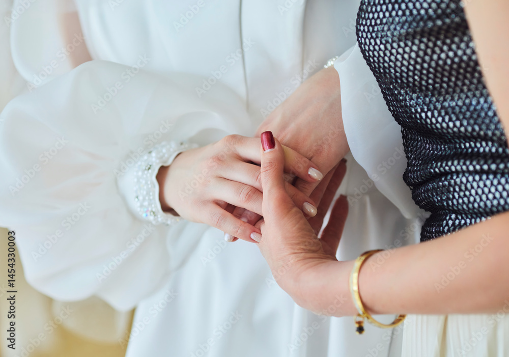 The hands of the bride and her mother. Emotions through hands The hands of the bride and her mother. Emotions through hands