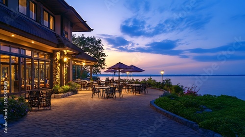 Lakeside patio restaurant at twilight, illuminated by warm lights.