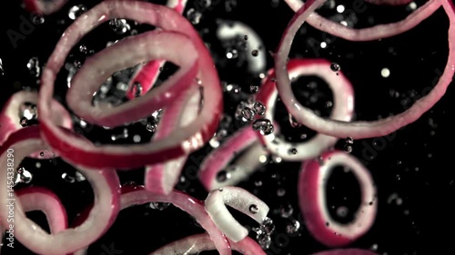 Sliced red onion rings fly up and fall down. Filmed on a high-speed camera at 1000 fps. High quality FullHD footage