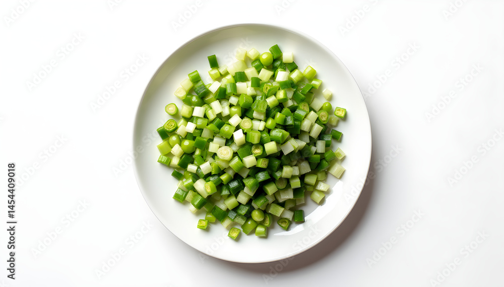 A white plate filled with chopped green onions on a white surface. A white plate filled with chopped green onions on a white surface.