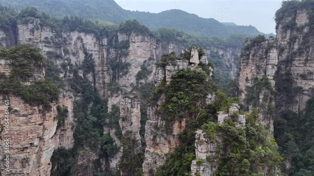 UNESCO Zhangjiajie Landscape from Drone – Iconic Stone Columns, Green Forest, and Cloud-Laden Sky UNESCO Zhangjiajie Landscape from Drone – Iconic Stone Columns, Green Forest, and Cloud-Laden Sky