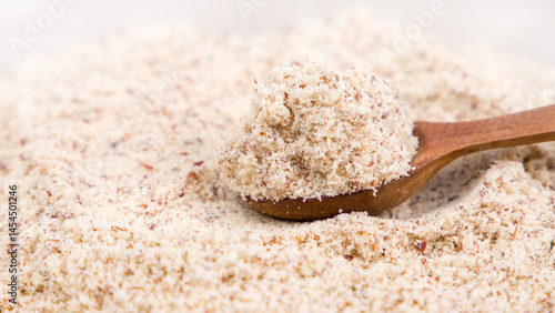 Cuadro en lienzo Almond flour in a wooden spoon, selective focus