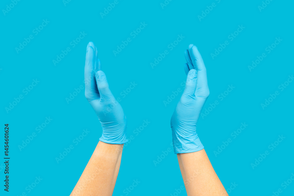 Fototapeta premium Medical nitrile gloves,blue cap, disposable medical mask on textured background. Medic protective clothing. Surgical latex gloves. Rubber gloves manufacturing.Medicine concept. Top view. Copy text