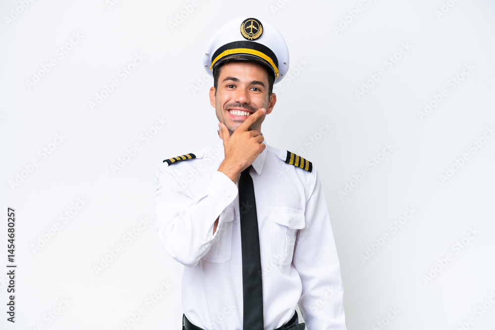 Airplane pilot over isolated white background smiling Airplane pilot over isolated white background smiling