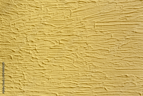 A wall with a white paint that has a texture. The texture is made up of lines and swirls.