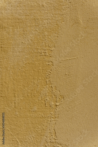 A wall with a brown color and a rough texture. The wall has a few scratches and marks.