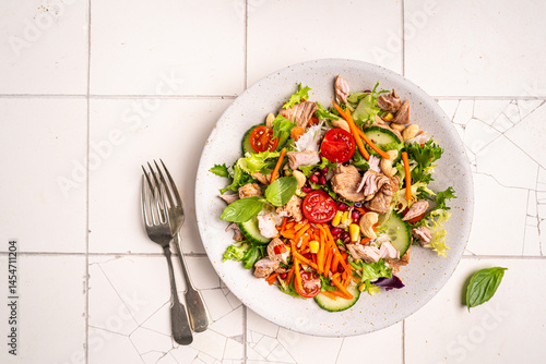 Obraz na płótnie Salad with chicken meat on white background, top view. Fresh vegetable salad with chicken. Meat salad with chicken fillet and fresh vegetables on plate. High quality photo w salonie